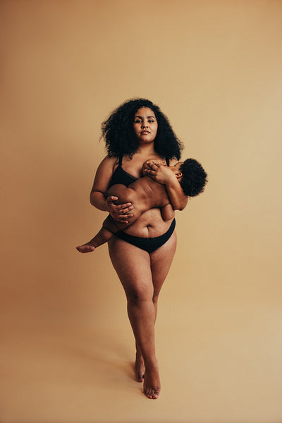 Strong African woman nursing her child
