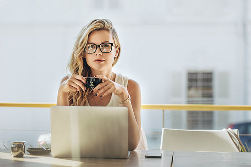 Businesswoman having coffee at cafe