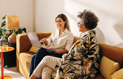 Creative businesswomen working together in an office lobby