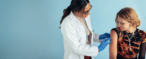 Doctor giving vaccine to a woman