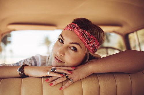Woman relaxing in a old car