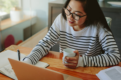 Asian female student working on her assignment 