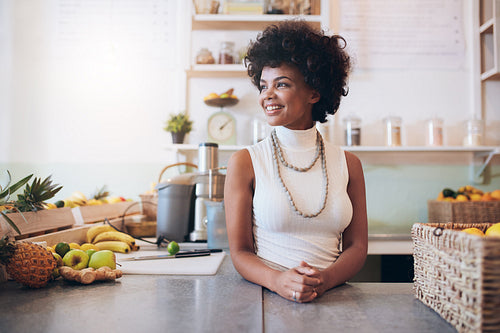Beautiful young woman working at juice bar