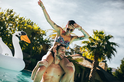 Couple enjoying a summer day in swimming pool