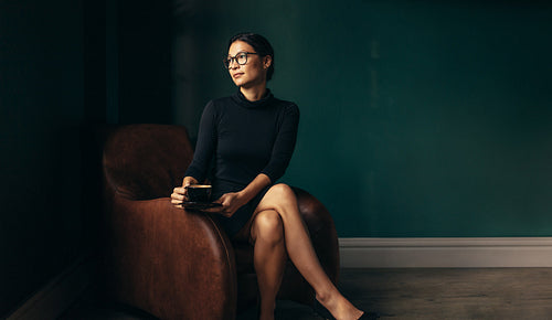 Thoughtful businesswoman relaxing in her office