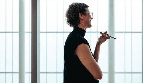 Interior designer in consultation holding a smartphone and engaging in creative discussion