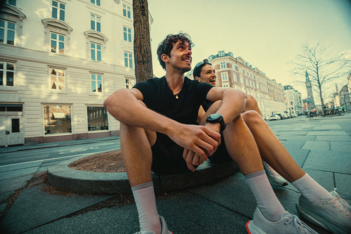 The running break after training shows a man and woman at rest in the city