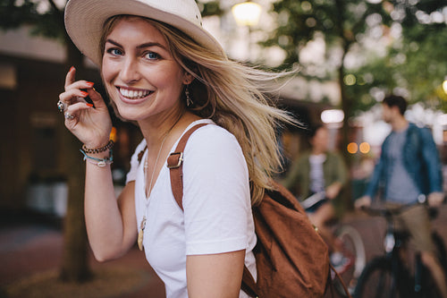 Attractive woman enjoying outdoors with friends at the back