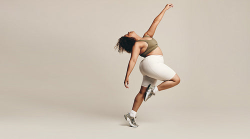 Dance and expression: Woman moving her body in a studio