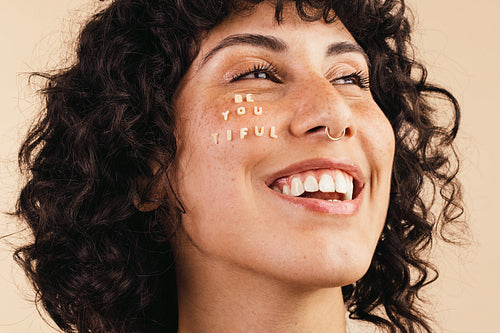 Self-loving woman embracing her natural face