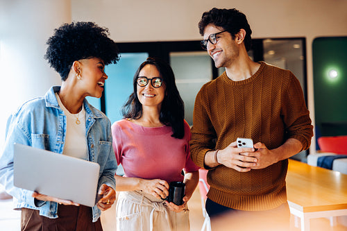 Strengthening team connection: Coworkers chat before diving into tasks