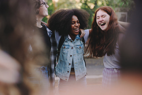 Happy teenage activists standing together in a circle