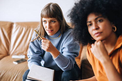Two young businesswomen having a meeting in an office