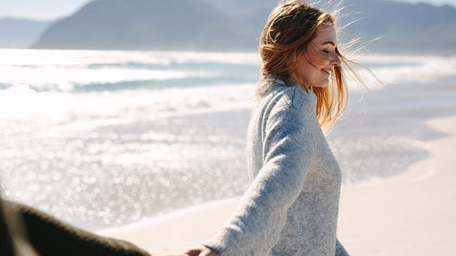 Woman walking along the beach with her boyfriend