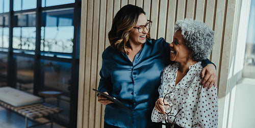 Building teamwork as business women collaborate in a modern office