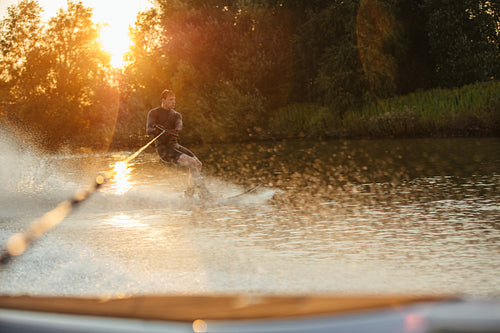 Man riding wakeboard on wave 