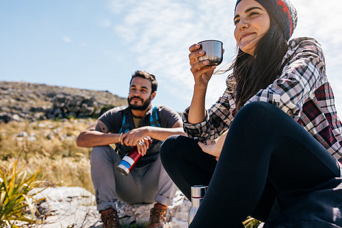 Two young friends taking a break during hike