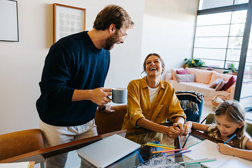 Family enjoying coffee and drawing at home