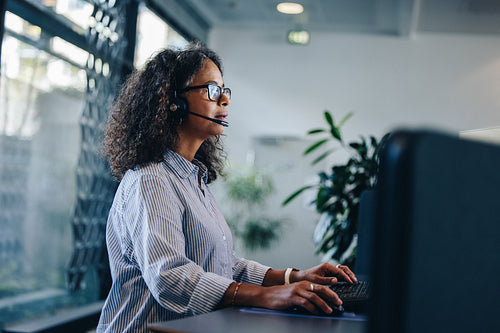 Business professional with headset working at her desk
