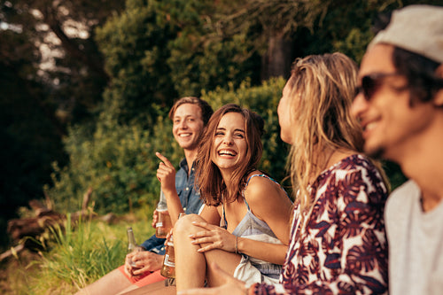 Cheerful young friends hanging out with beers