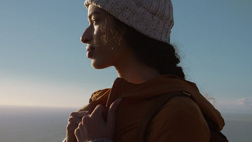 Female in warm clothing enjoying the view from mountain