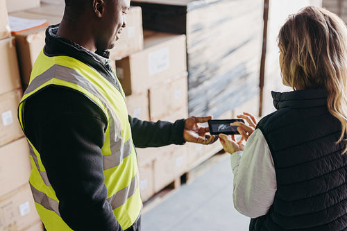 Warehouse worker e-signing a dock receipt after receiving a delivery