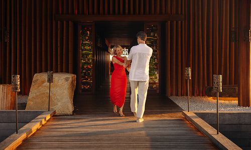 Couple arriving for premium dining at luxury resort restaurant