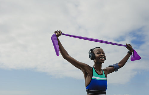 Sporty woman exercising with resistance band