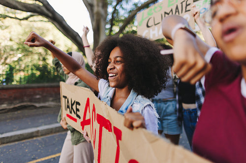 Cheerful young people standing up against climate change