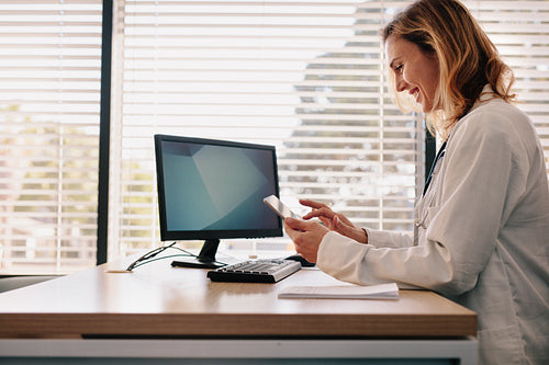 Female doctor using her digital tablet in the consultation