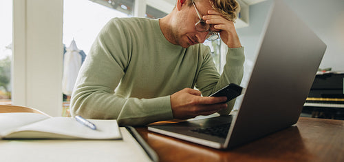 Man looking stressed while working from home