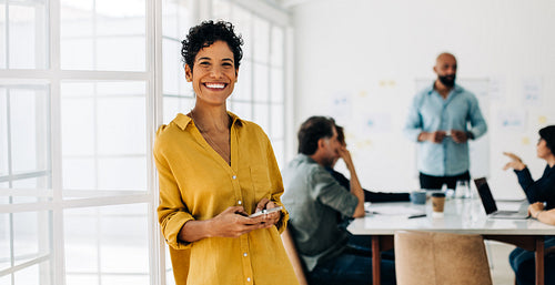 Portrait of a business woman using a mobile phone in an office
