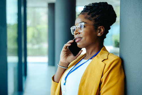 African businesswoman talking on her phone in modern office