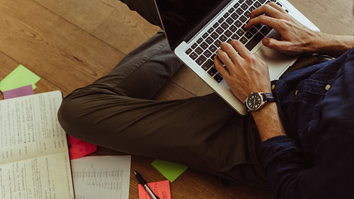 Birdseye shot of man working on his laptop from home