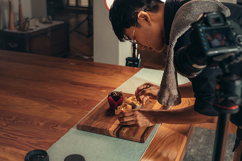 Photographer arranging food for photography vlog