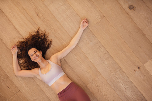 Woman relaxing on floor after workout
