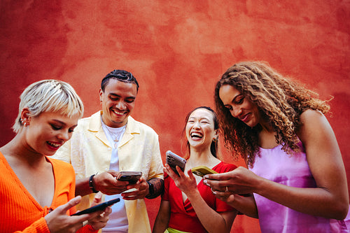 Friends enjoy online connections while using smartphones outdoors