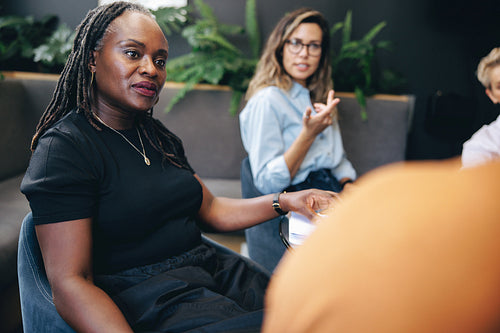 Professional business women engaging in a team discussion with their colleagues