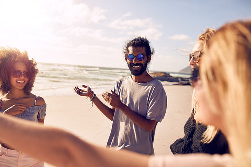Group of friends having fun on the beach