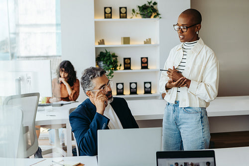 Creative professionals discussing business project in modern office