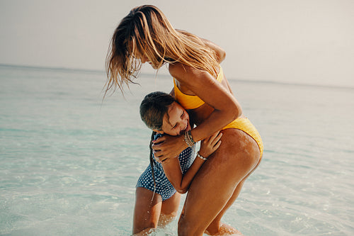 Island bliss: Mother and child enjoying fun in the shallows