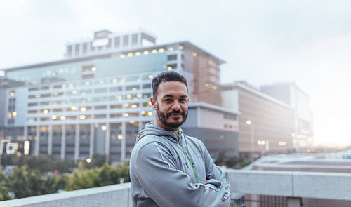 Man in tracksuit standing with hands folded