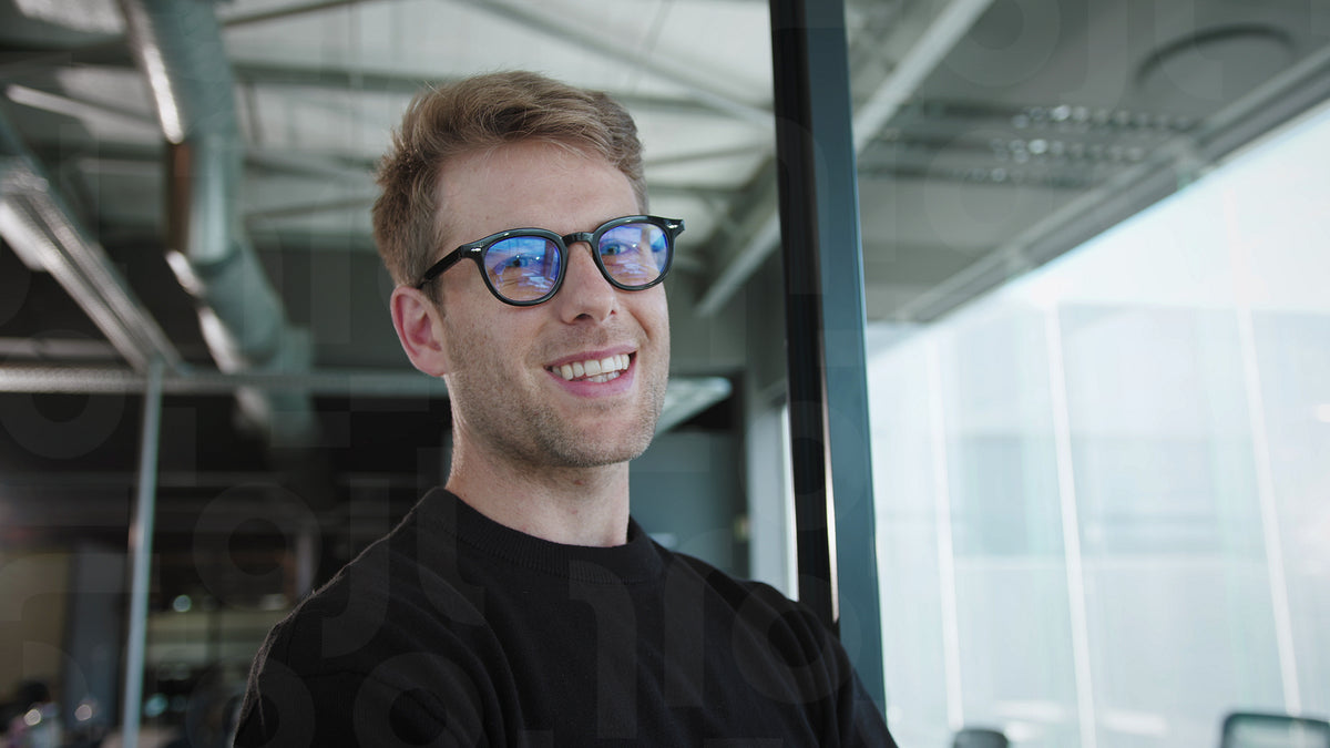Business man standing in an office and smiling at the camera – Jacob ...