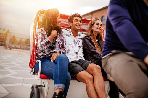 Group of young friends enjoying tricycle ride