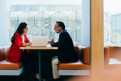 Two senior executives having a conversation during a productive workplace meeting