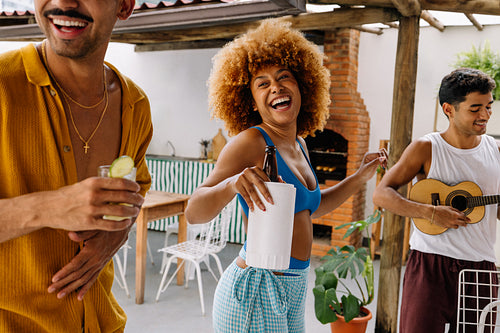 Three friends enjoying a lively pagode gathering with music and cavaquinho