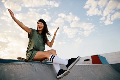 Woman skateboarder enjoying a day at skate park