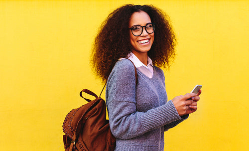 African woman with bag and phone