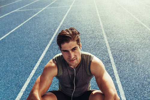 Sprinter relaxing on running track