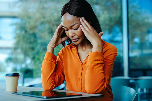 Frustrated businesswoman coping with stress in a modern office
